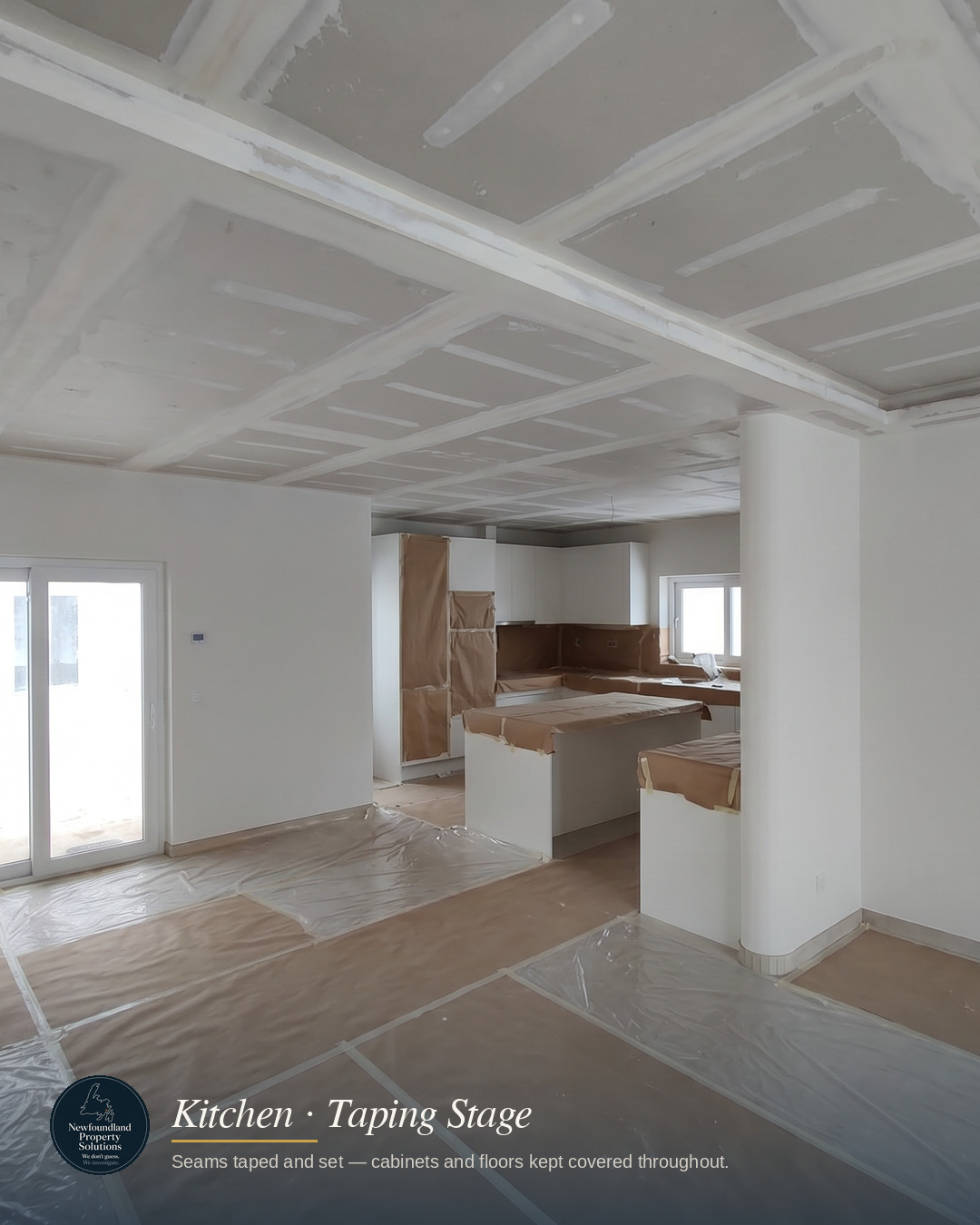 Taped ceiling seams with cabinets and floors covered